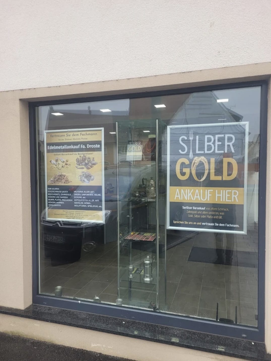 Schaufenster mit Silber-und-Gold-Beschriftung der Filiale Mengen